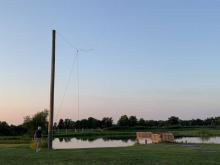 Hoisting up the loop antenna on one of teh support poles 